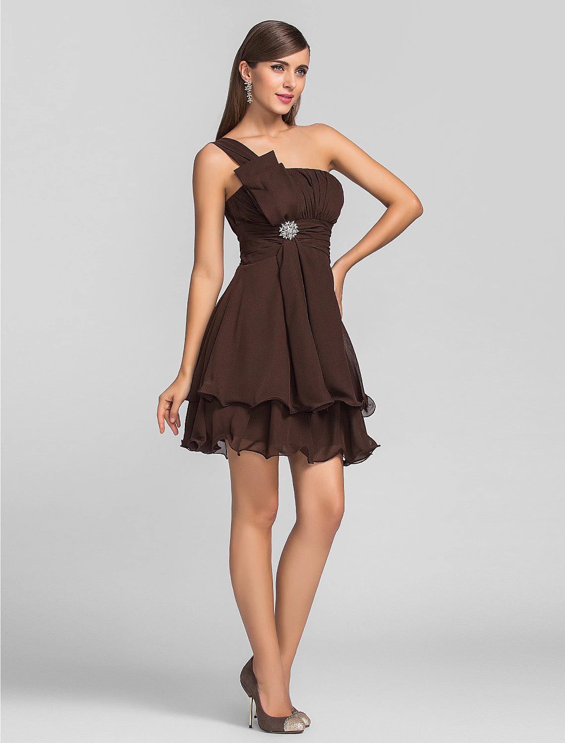 Full-length view of the model in the elegant one-shoulder mini dress.