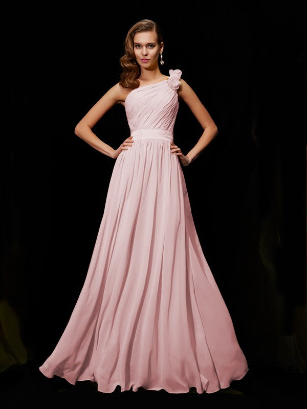 Full length view of a woman posing in a flowing chiffon bridesmaid dress.