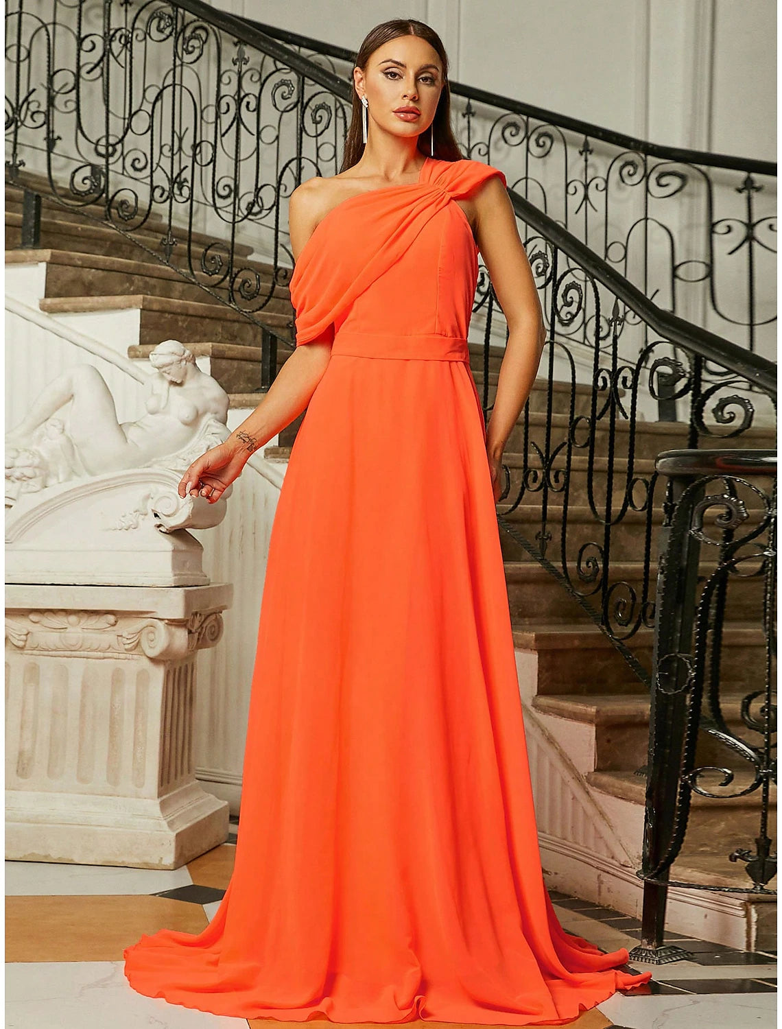 Model wearing an elegant one-shoulder A-line evening gown with short sleeves and pleats.