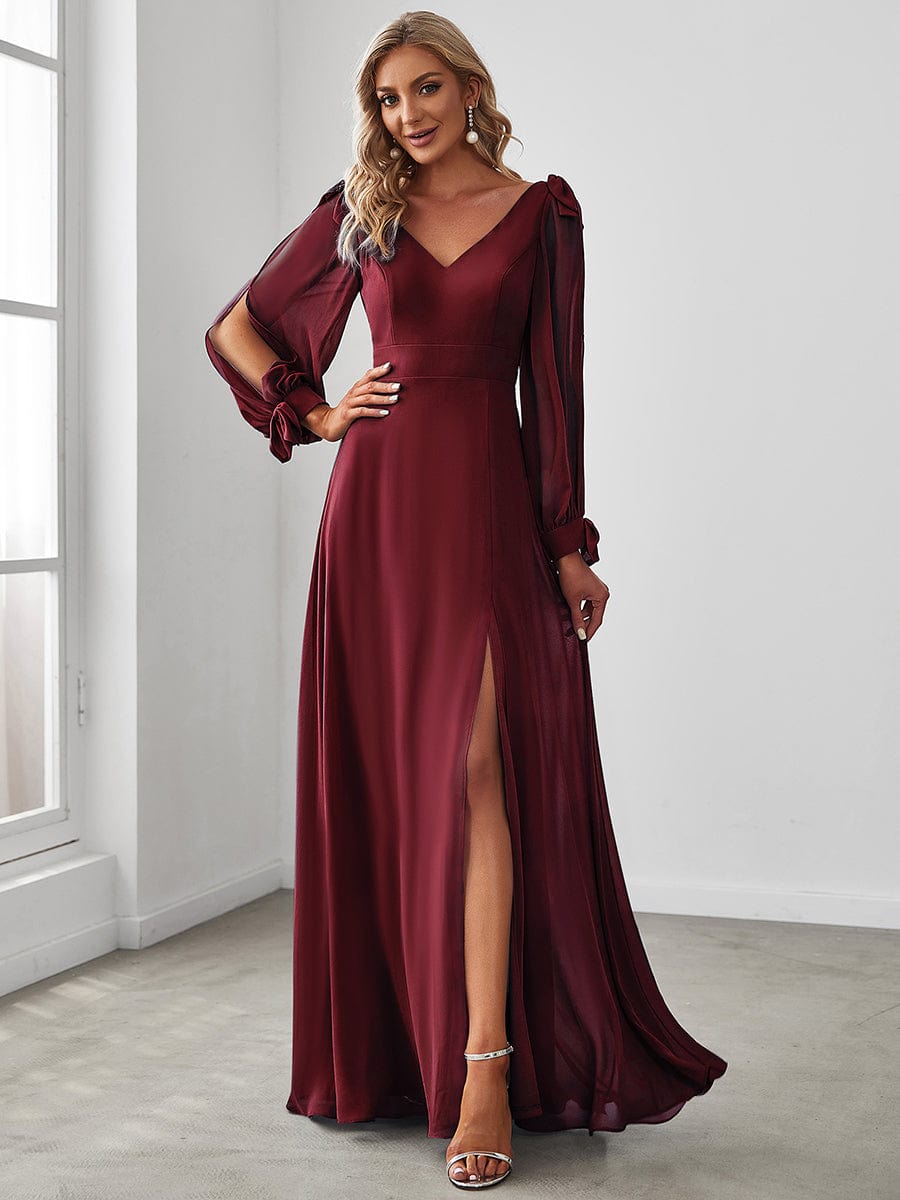 Model wearing a red A-line open lantern sleeve bridesmaid dress.