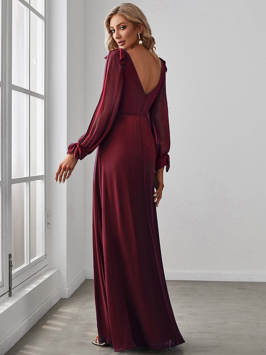 Side view of a model in a red A-line open lantern sleeve bridesmaid dress.