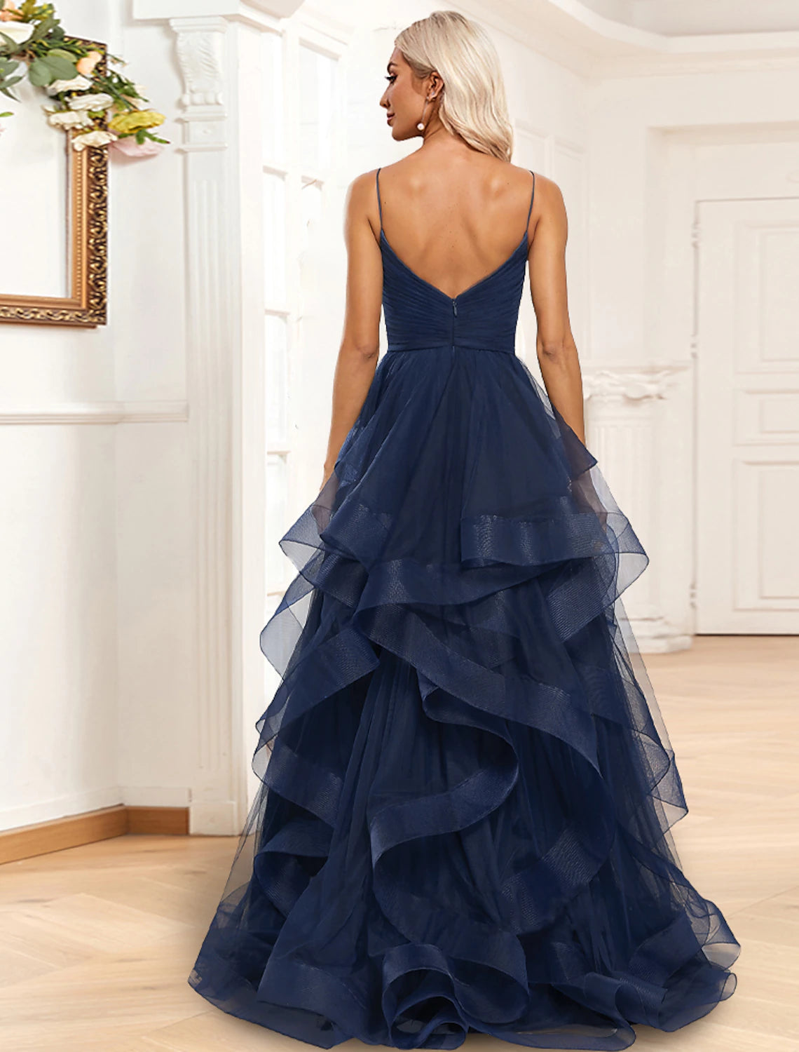 Back view of the A-line organza evening gown, showing the sweep train and spaghetti strap detail.