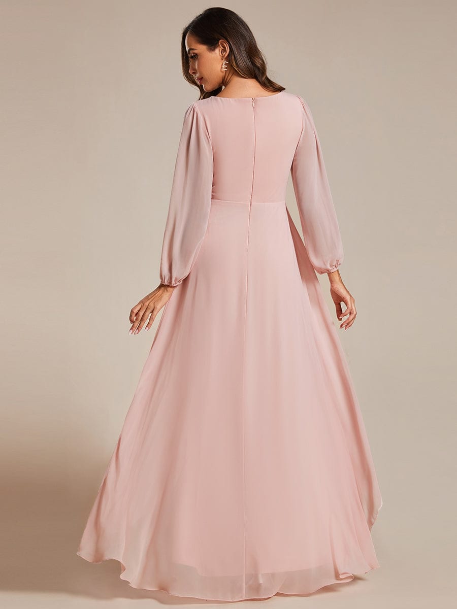 Close-up of the sheer long lantern sleeve and pleated detail on the pink chiffon dress.