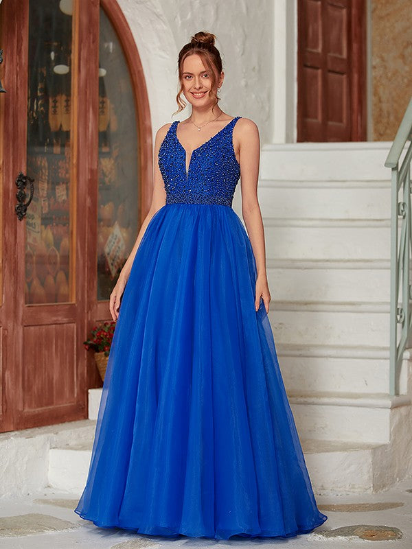 Side profile of the floor-length V-neck beaded dress.