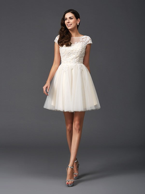 Side view of the elegant short sleeve party dress with applique details.