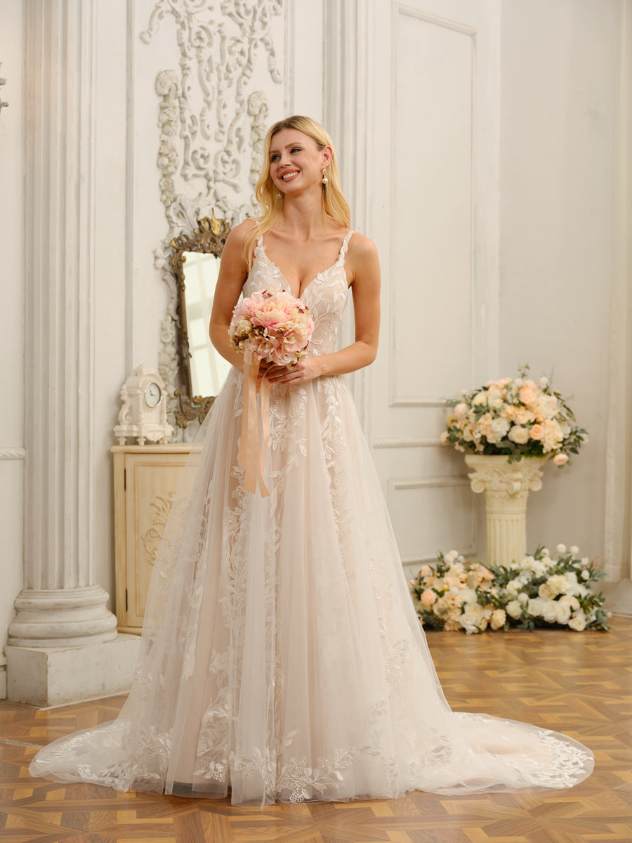Back view of the elegant wedding dress, highlighting the spaghetti straps and train.