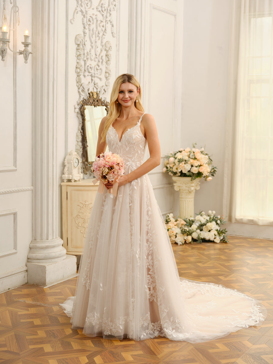 Close-up of the delicate floral appliques on the bodice and skirt of the wedding dress.