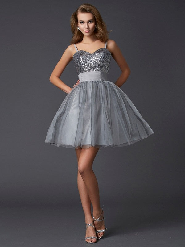 Front view of a model wearing an elegant short A-line organza homecoming dress with spaghetti straps.