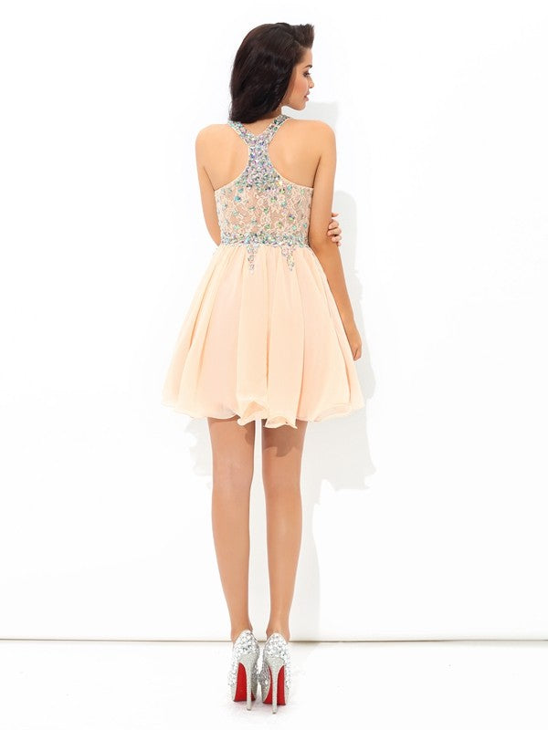 Close-up of sparkling rhinestone straps and flowing chiffon fabric on the dress.