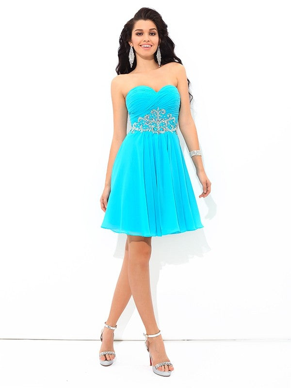 Detail of the chiffon fabric and pleats on the short cocktail dress.