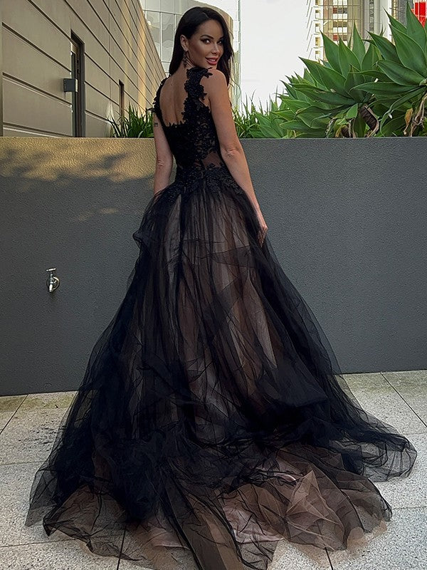 Back view of a periwinkle tulle prom dress featuring a sweep train.