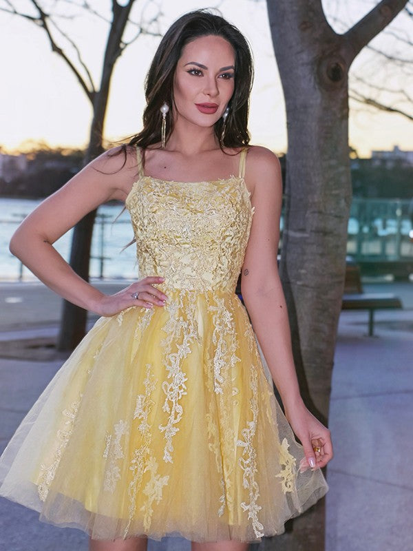 Elegant A-Line Princess tulle homecoming dress with spaghetti straps and applique.