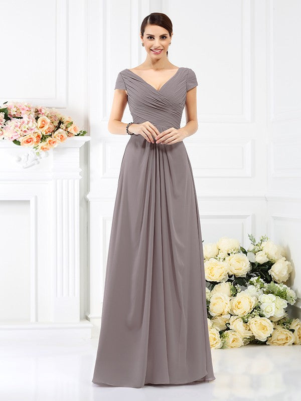 Woman in an elegant A-line V-neck short sleeve long chiffon bridesmaid dress.