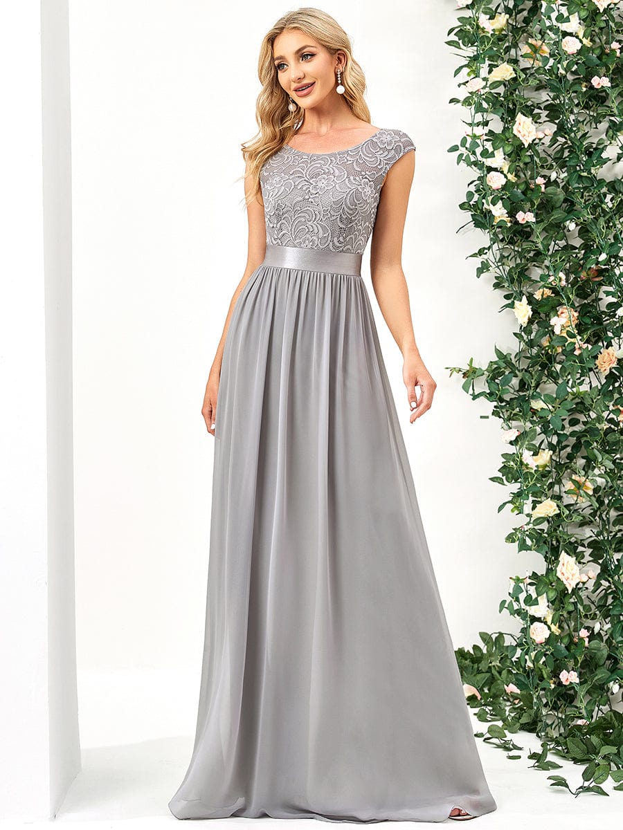 Close-up of the lace bodice and round neck of a grey bridesmaid dress.