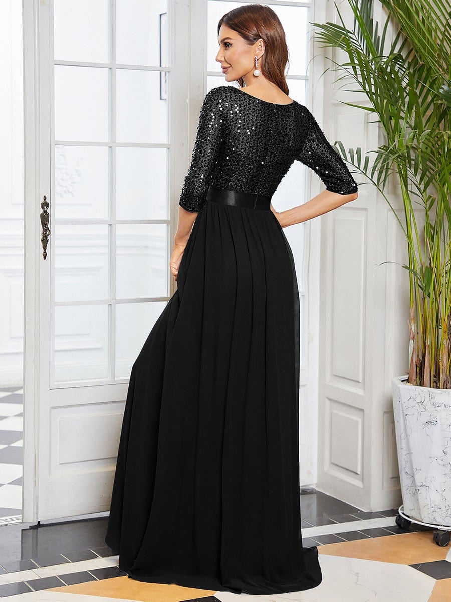 Back view of a woman in a black long sleeve sequin evening dress.