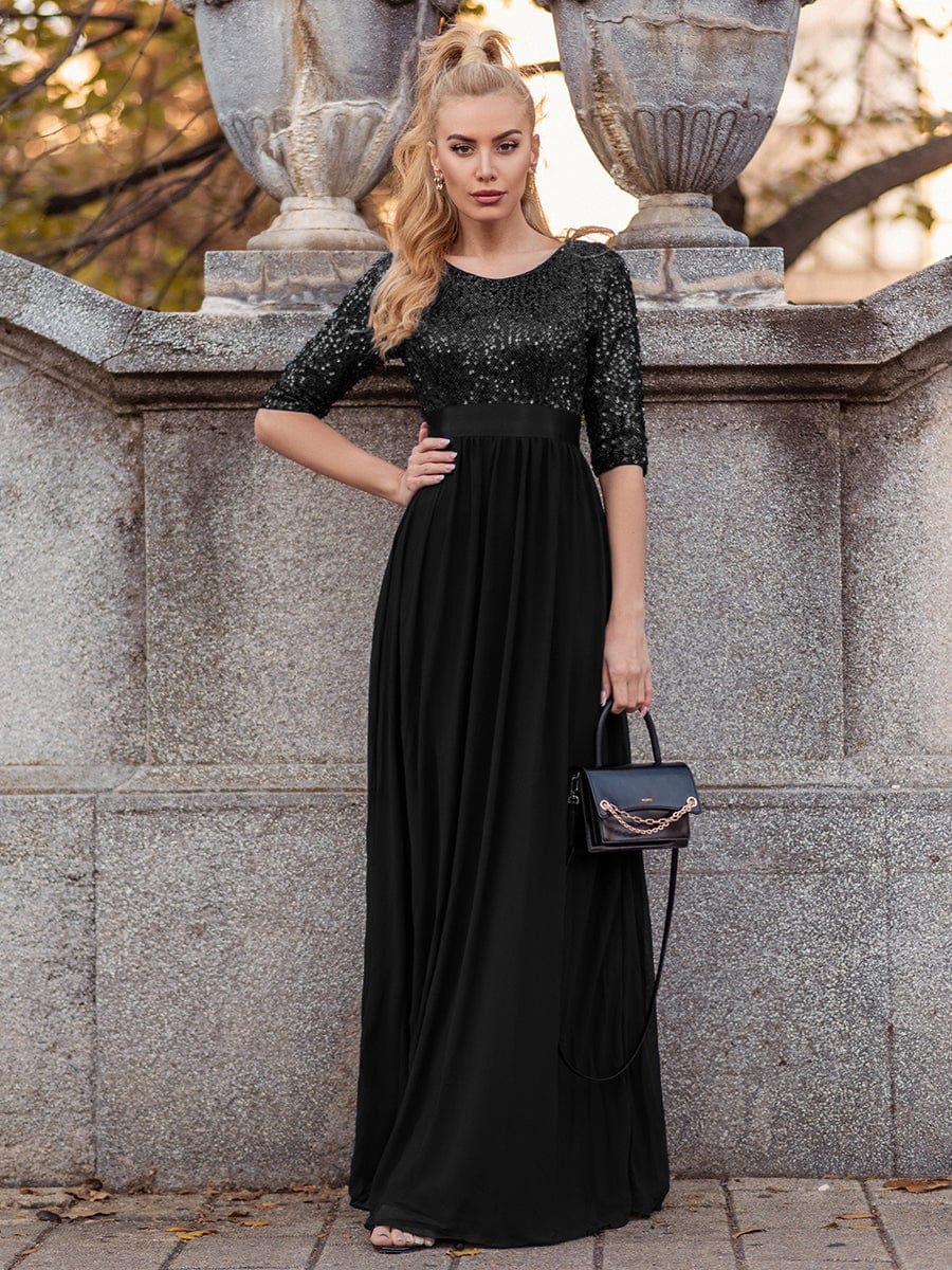 Close-up of the sequin detail on a black long sleeve evening dress.