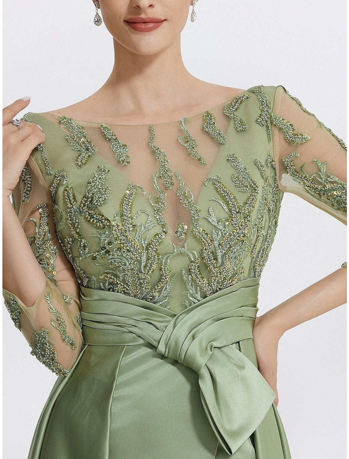 Close-up of the jewel neck and delicate embroidery appliques on the Weitese evening gown.