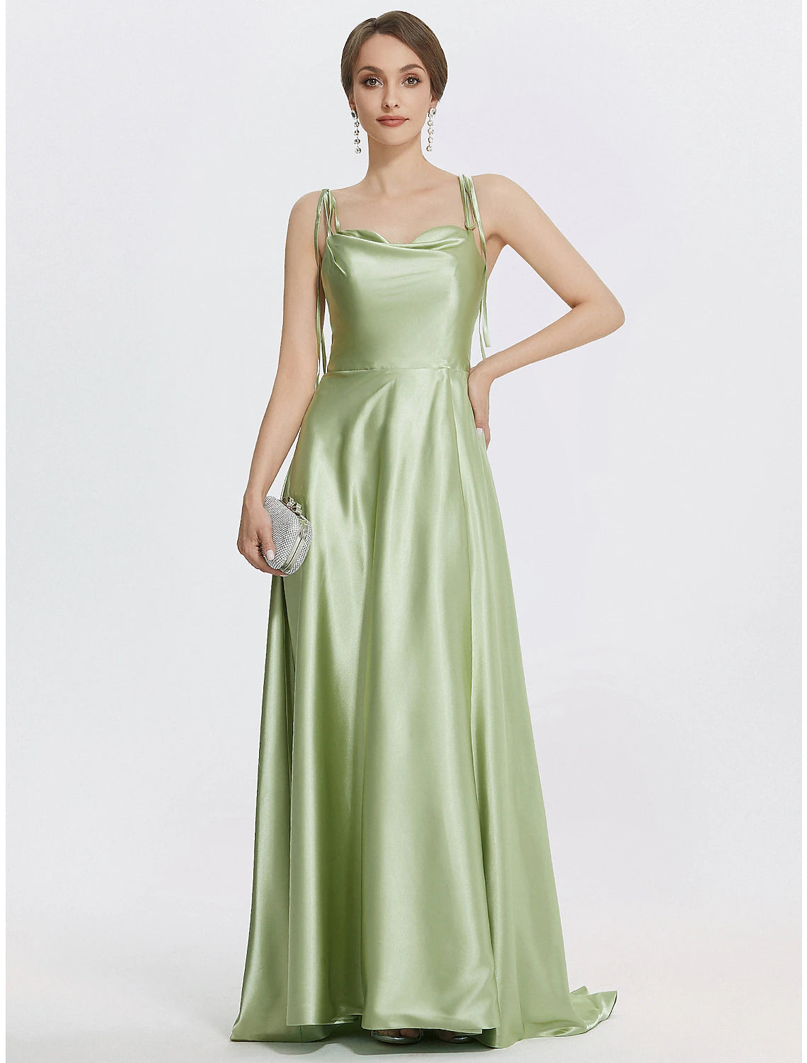 Model wearing a sleeveless A-line satin evening gown with spaghetti straps and a ruched slit.