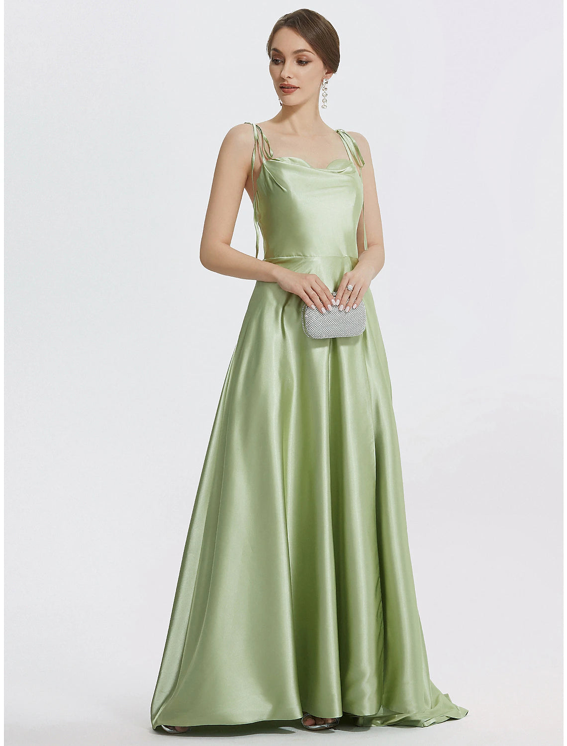 Close-up of the ruched slit detail on the satin evening gown.