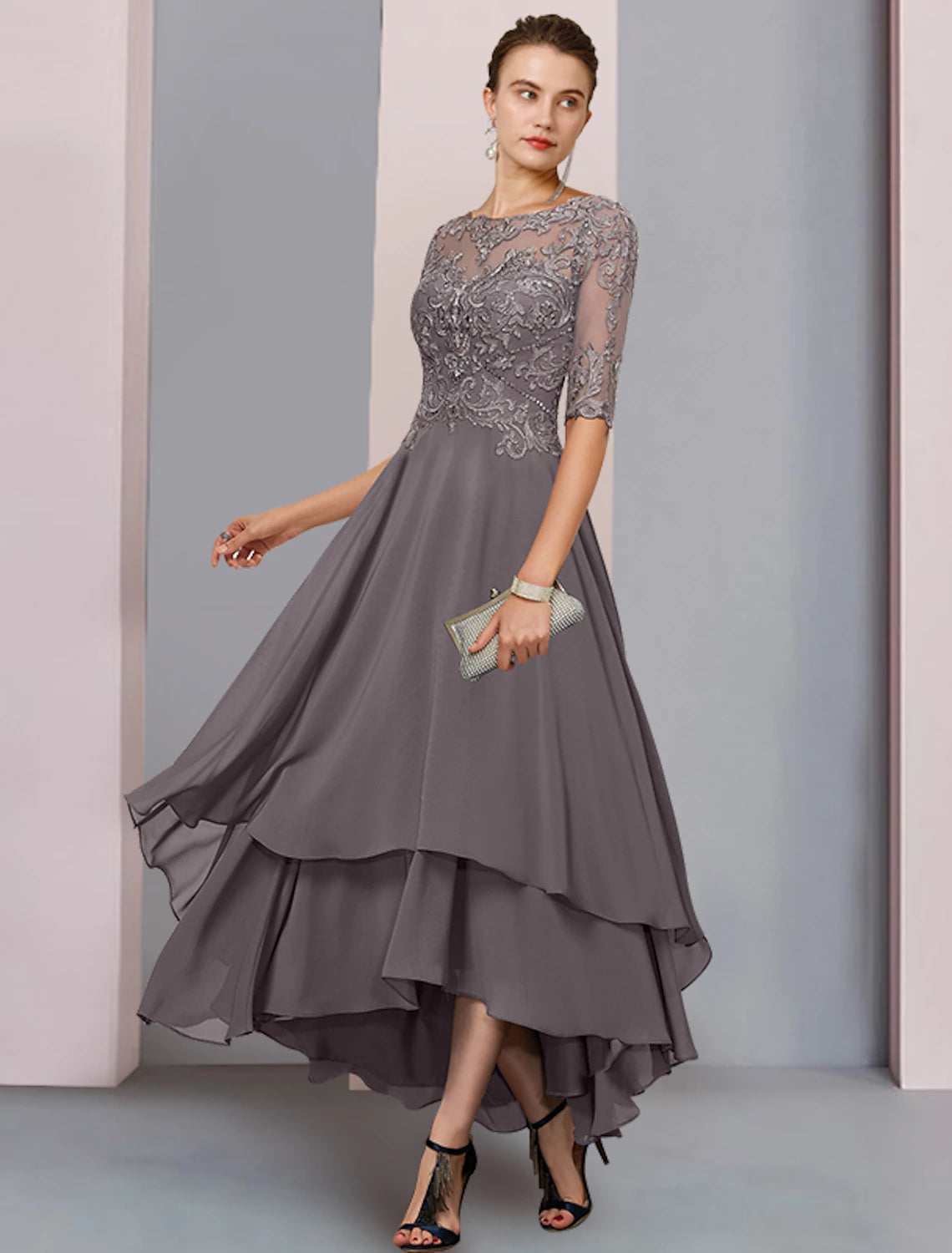 Elegant A-line tea-length dress with scoop neck and 3/4 sleeves, worn by a woman.