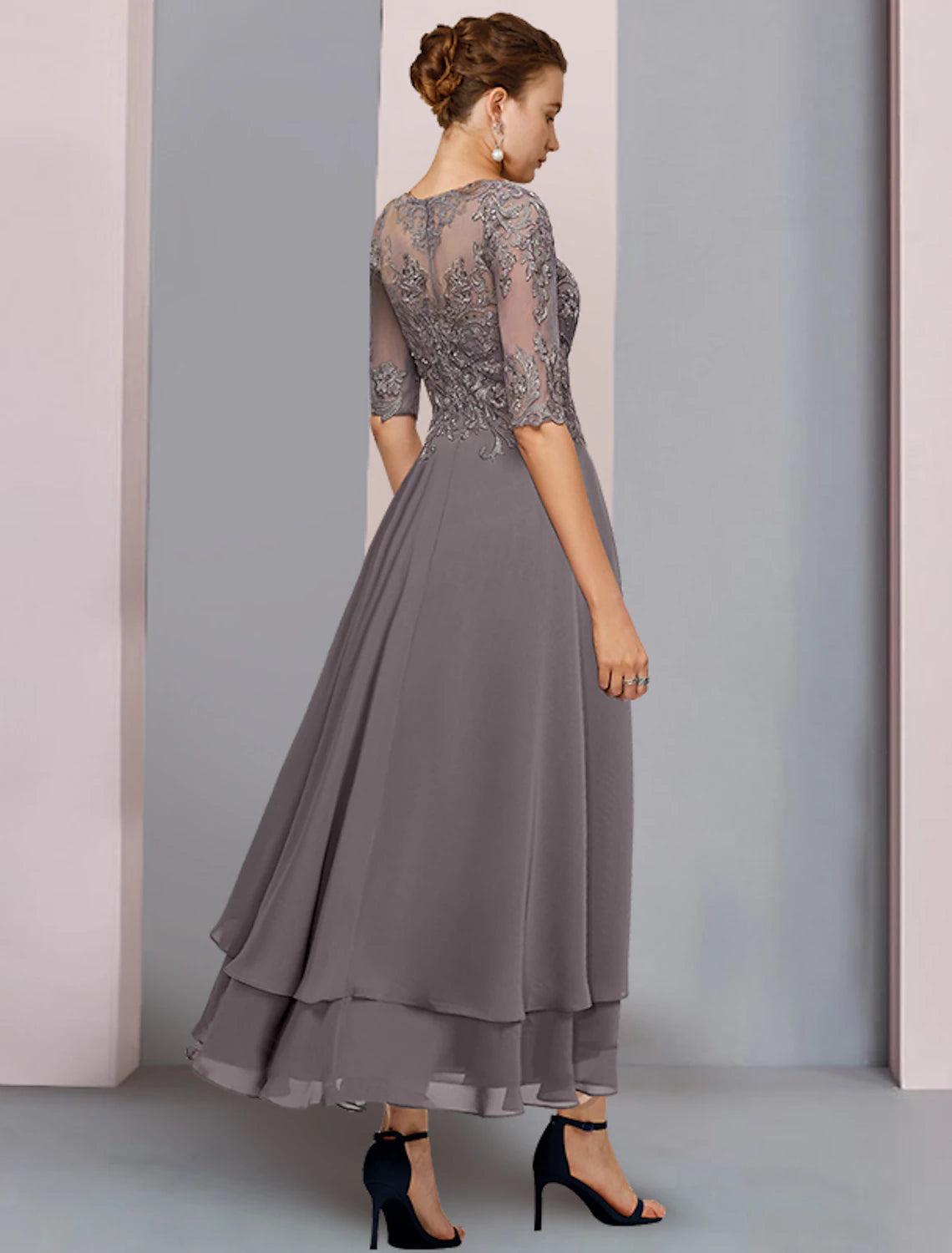 Formal chiffon lace dress with beading and asymmetrical hem, worn by a woman.
