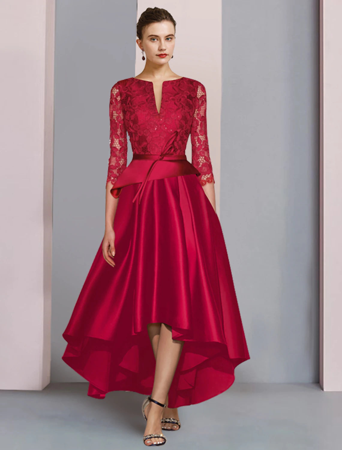 Elegant A-line mother of the bride dress with scoop neck, 3/4 sleeves, and high-low tea length hem.