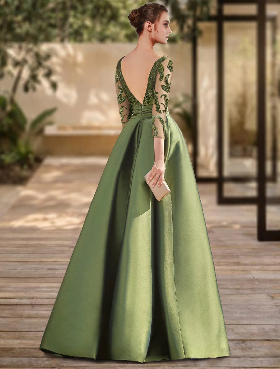 Back view of the A-line lace evening gown, showing the open back and floor-length slit.