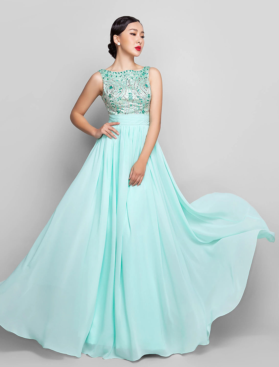 Woman wearing a floor-length A-line scoop neck beaded and sequin chiffon dress with ruched details and bows.