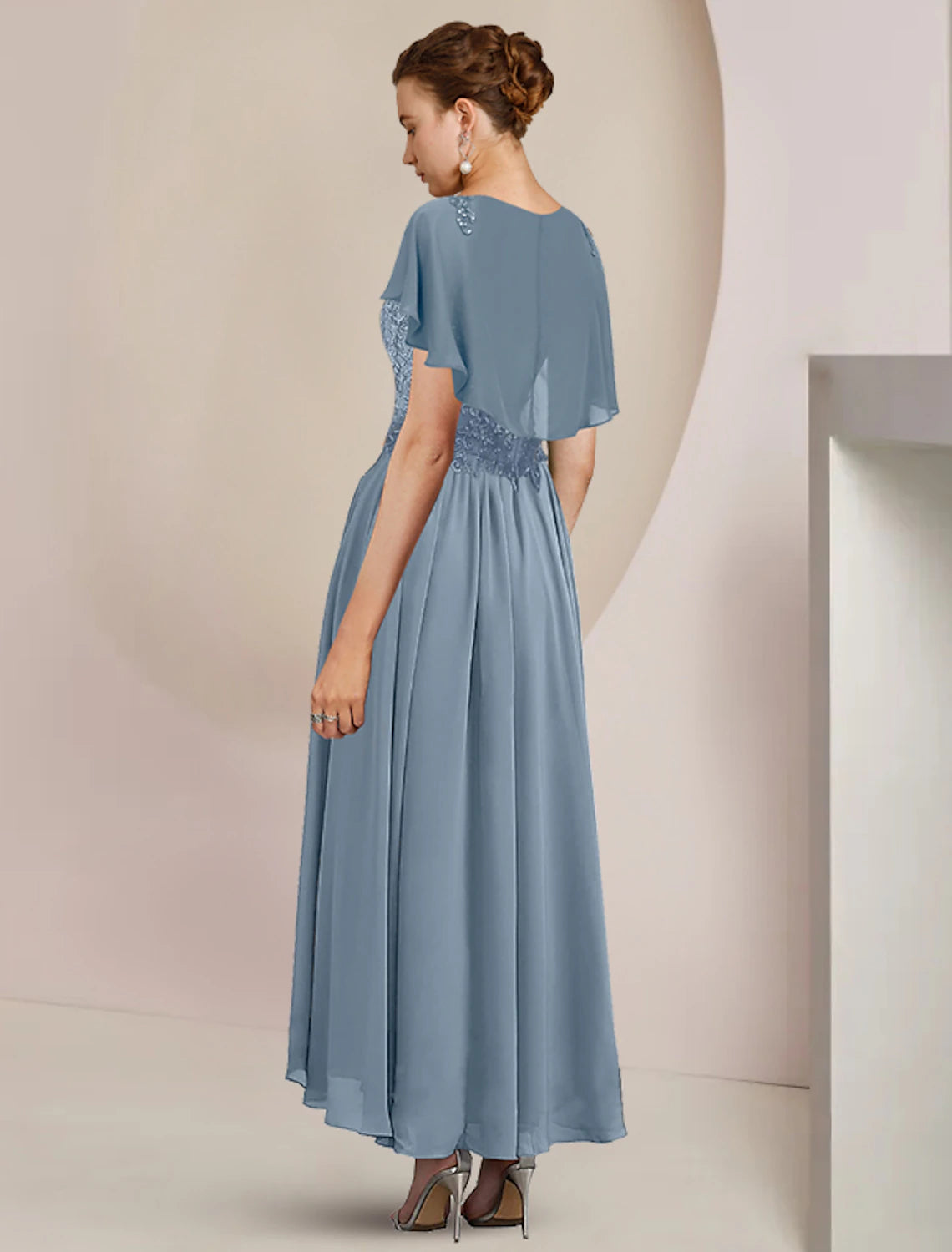 Side view of the A-line mother of the bride dress, showing the tea length and chiffon fabric.