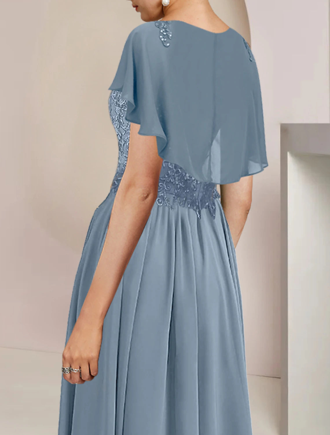 Back view of the elegant sleeveless A-line mother of the bride dress.