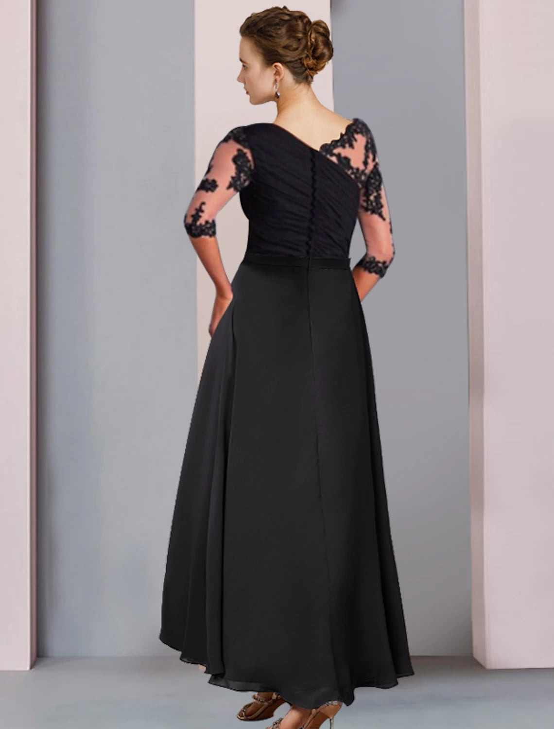 Back view of elegant blue A-line high-low tea length dress with asymmetrical hem.