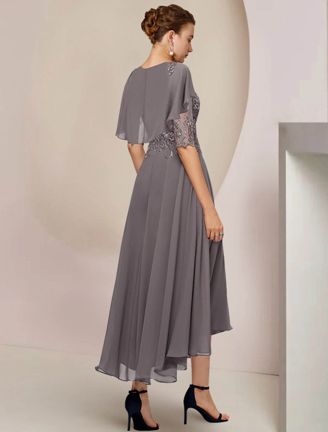 Back view of the A-line mother of the bride dress, showcasing the chiffon lace and asymmetrical hem.