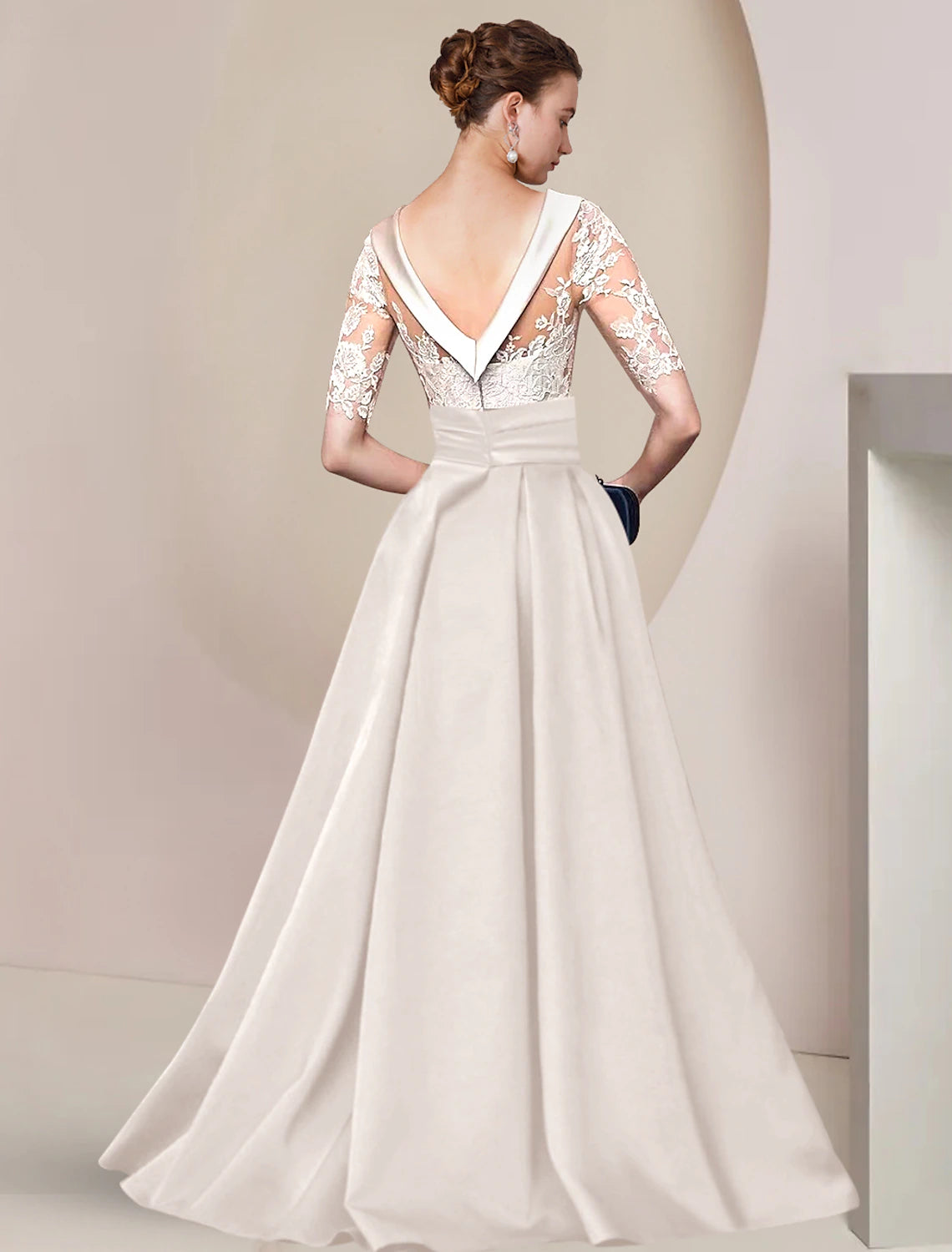 Close-up of the satin lace and ruched appliques on the back of the formal dark blue gown.