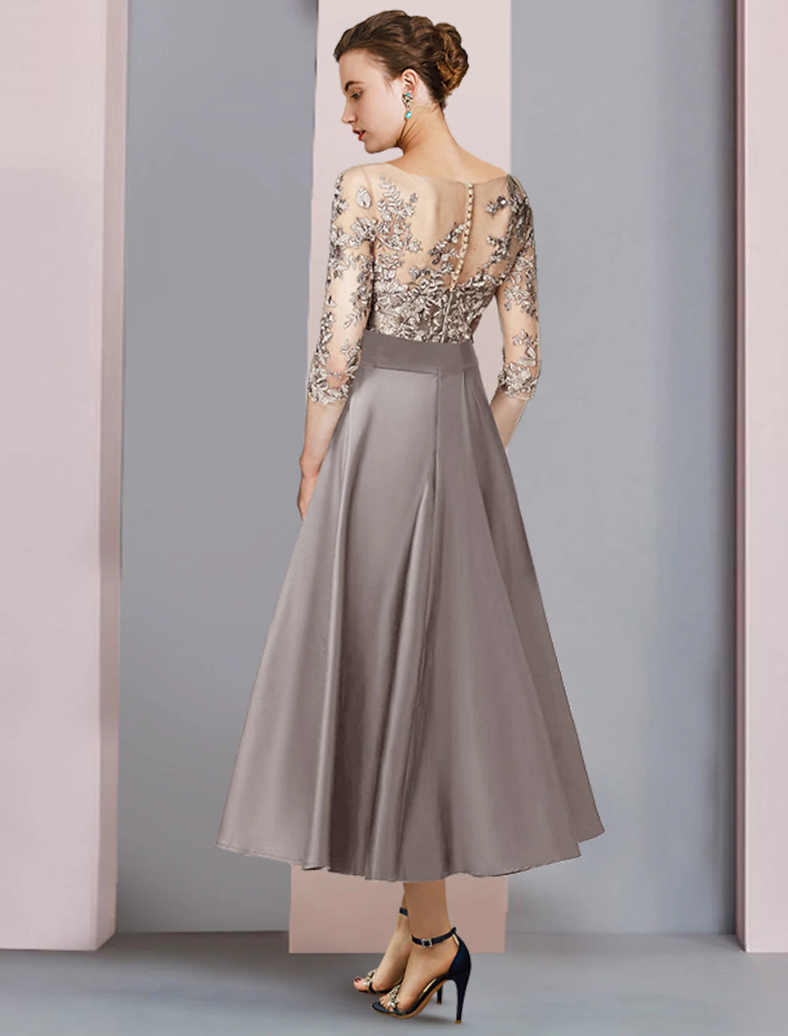 Close-up of the satin lace fabric and bow applique detail on the Weitese dress.