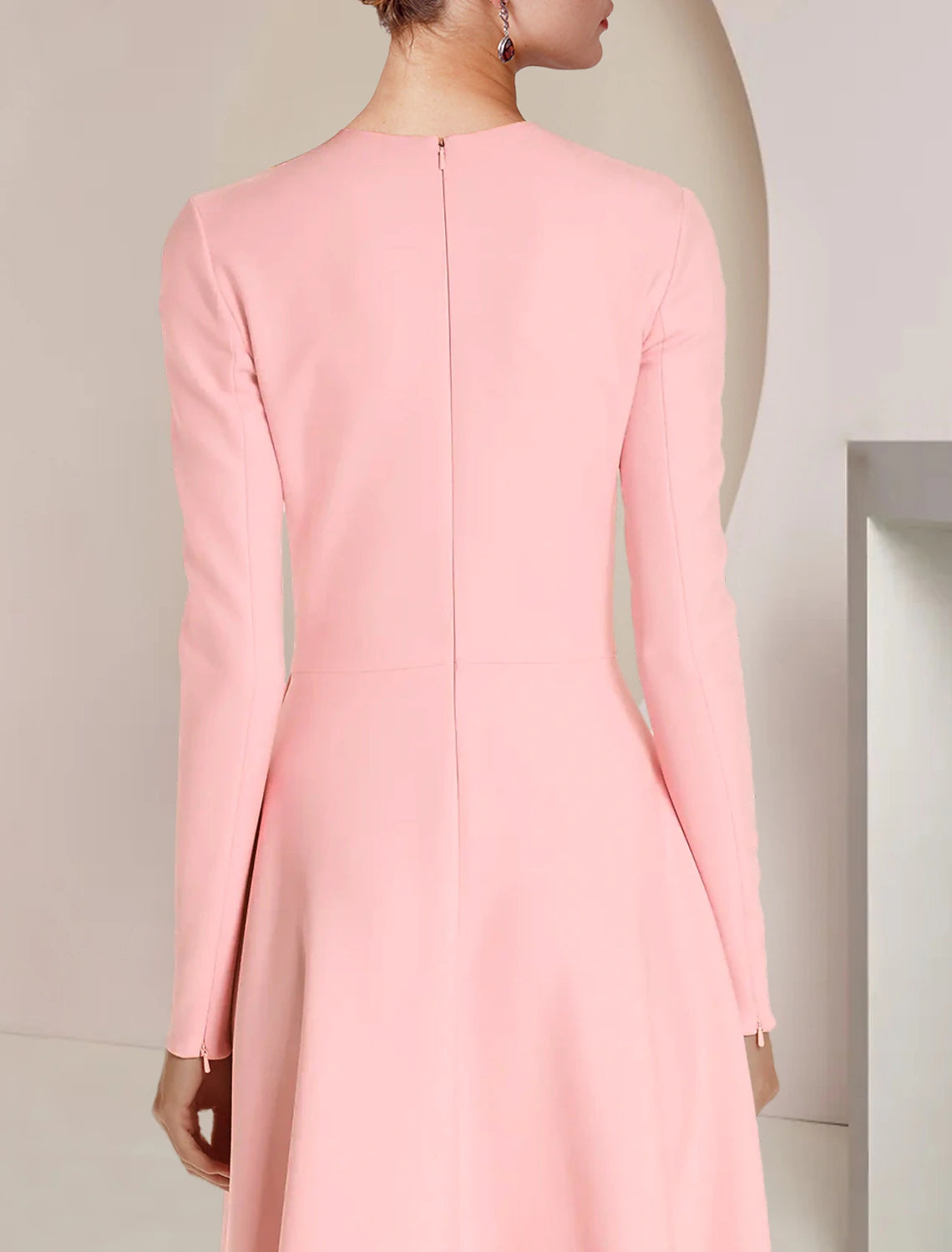 Close-up of the stretch fabric and ruffle detail on the elegant long sleeve dress.