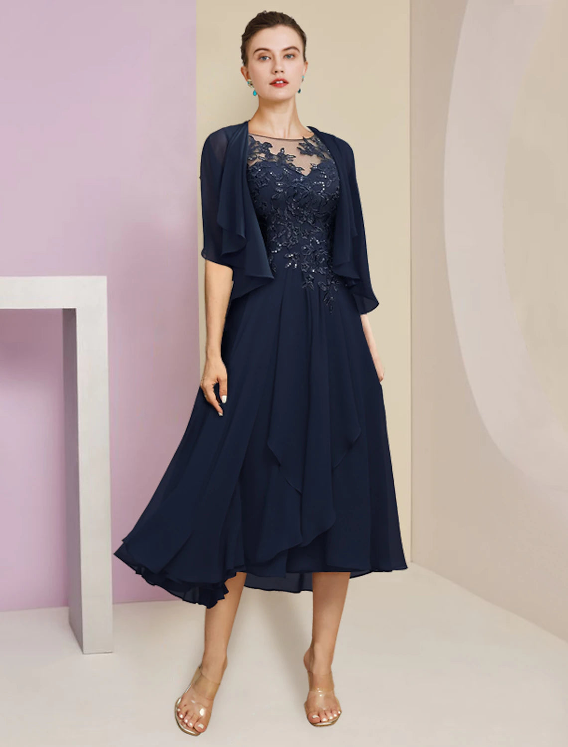 A woman wearing the elegant two-piece A-line mother of the bride dress.