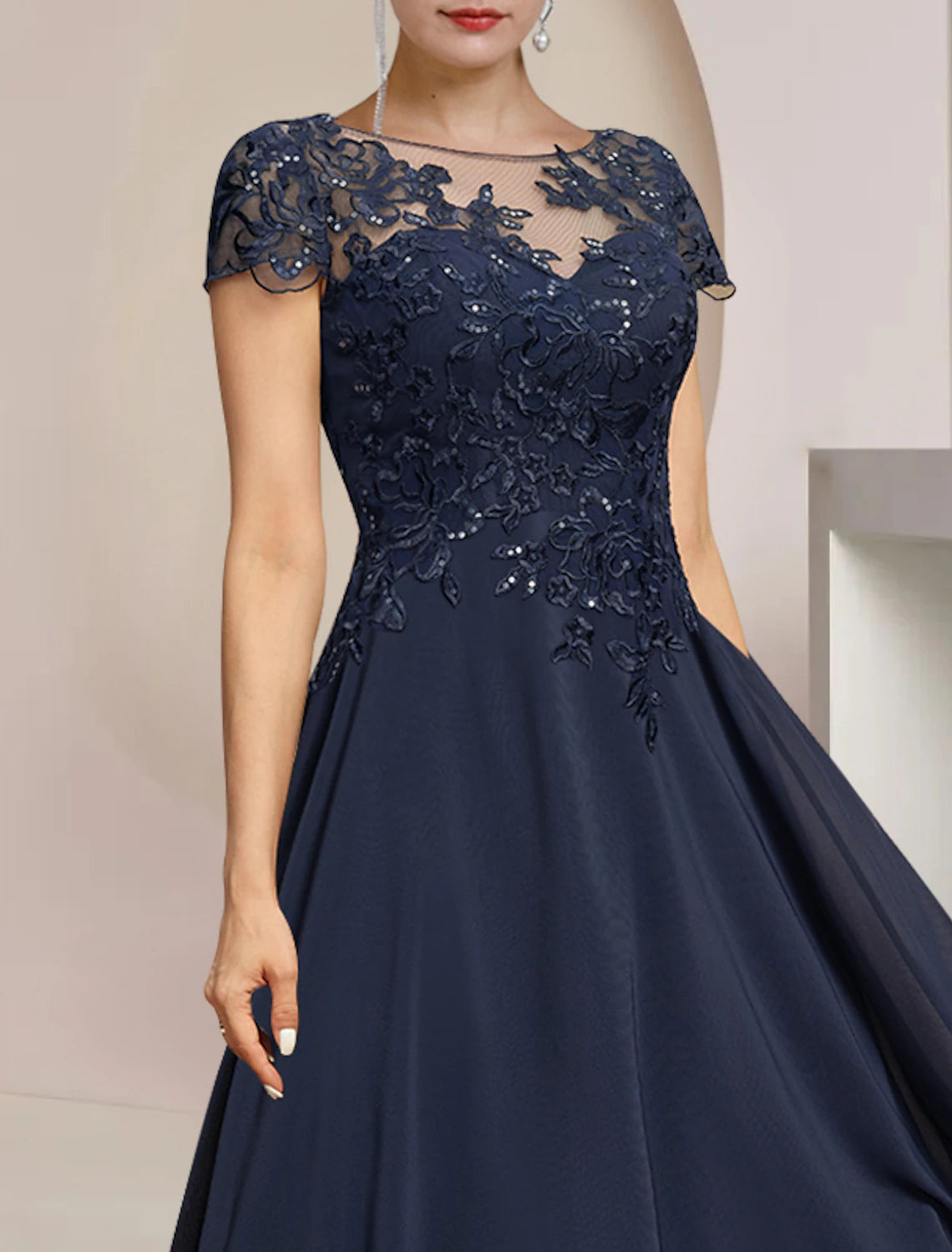 Back view of formal tea length dress with sequin appliques.