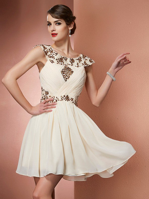 Model wearing a short A-line chiffon bridesmaid dress with scoop neck and beaded appliques.