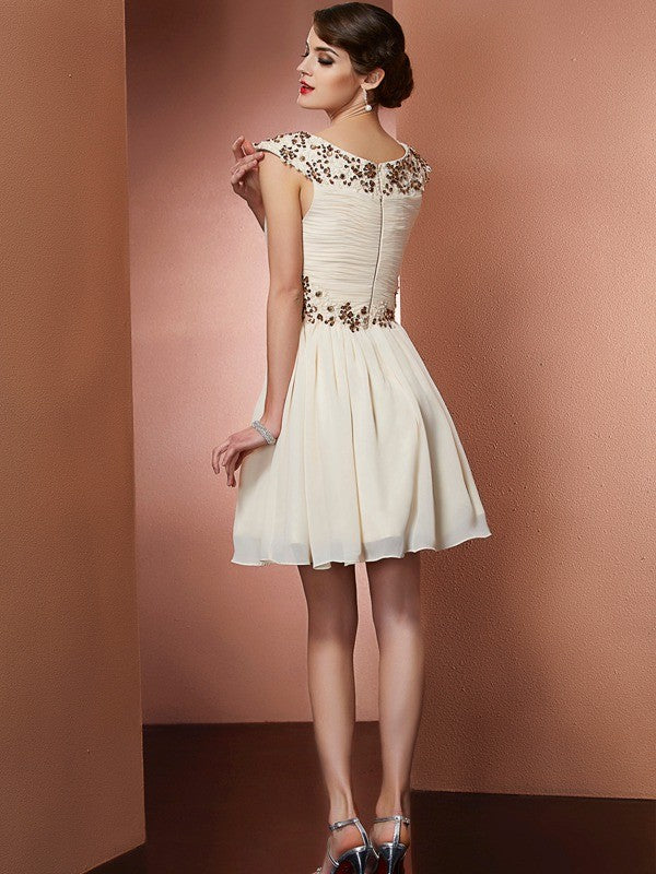 Back view of a model in a sleeveless short chiffon bridesmaid dress with elegant beading.