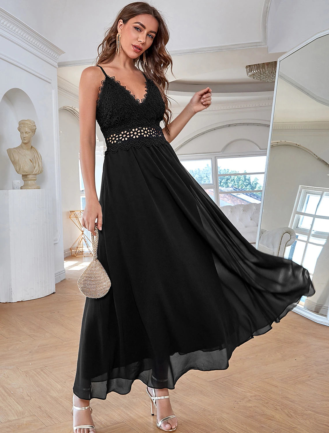 Woman wearing a sparkling A-line sequin chiffon evening gown with spaghetti straps.