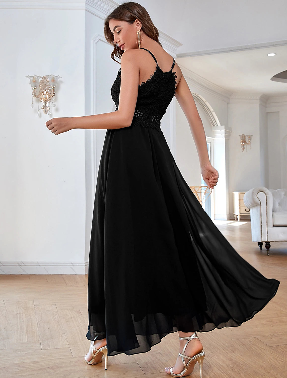 Elegant woman posing in a sleeveless ankle-length formal dress with sequin details.