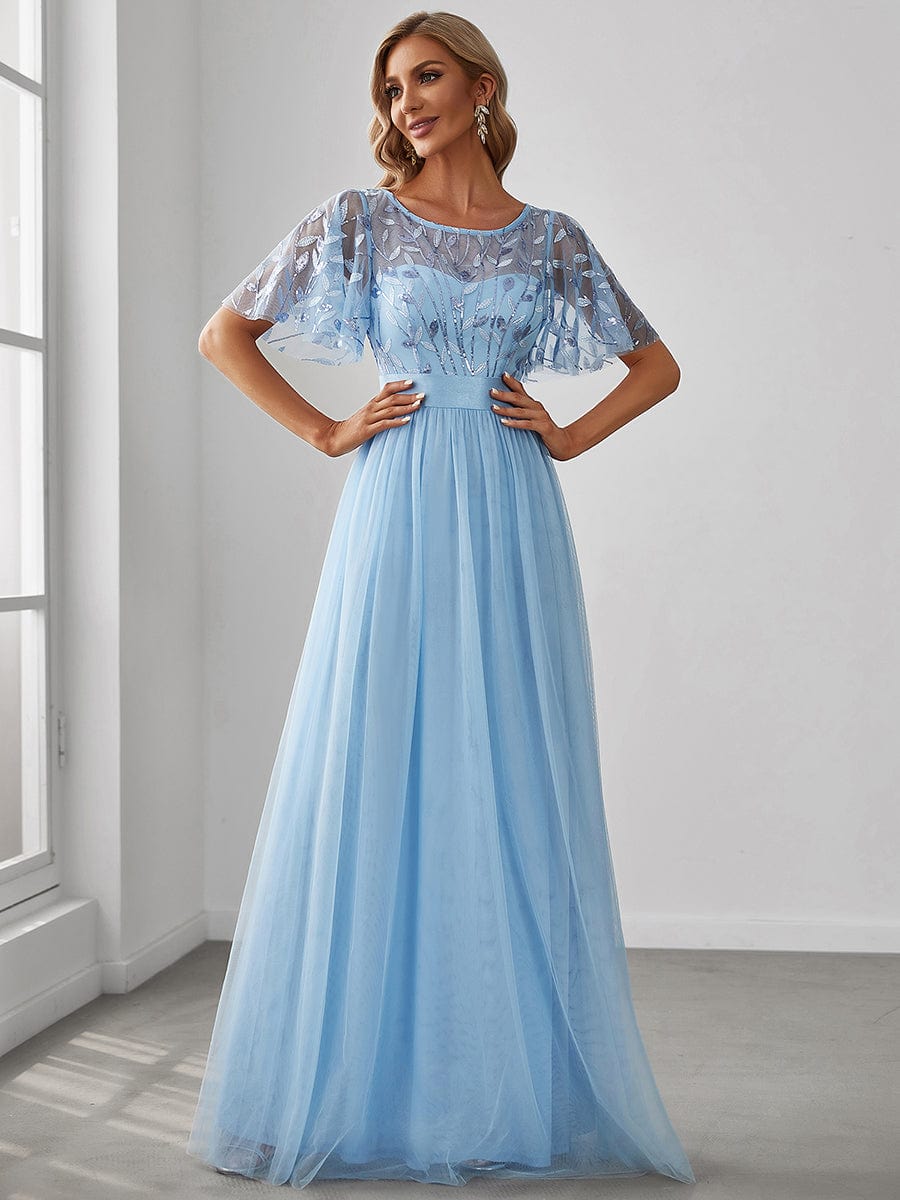 Woman wearing a blue A-line short sleeve embroidered floor length evening gown.