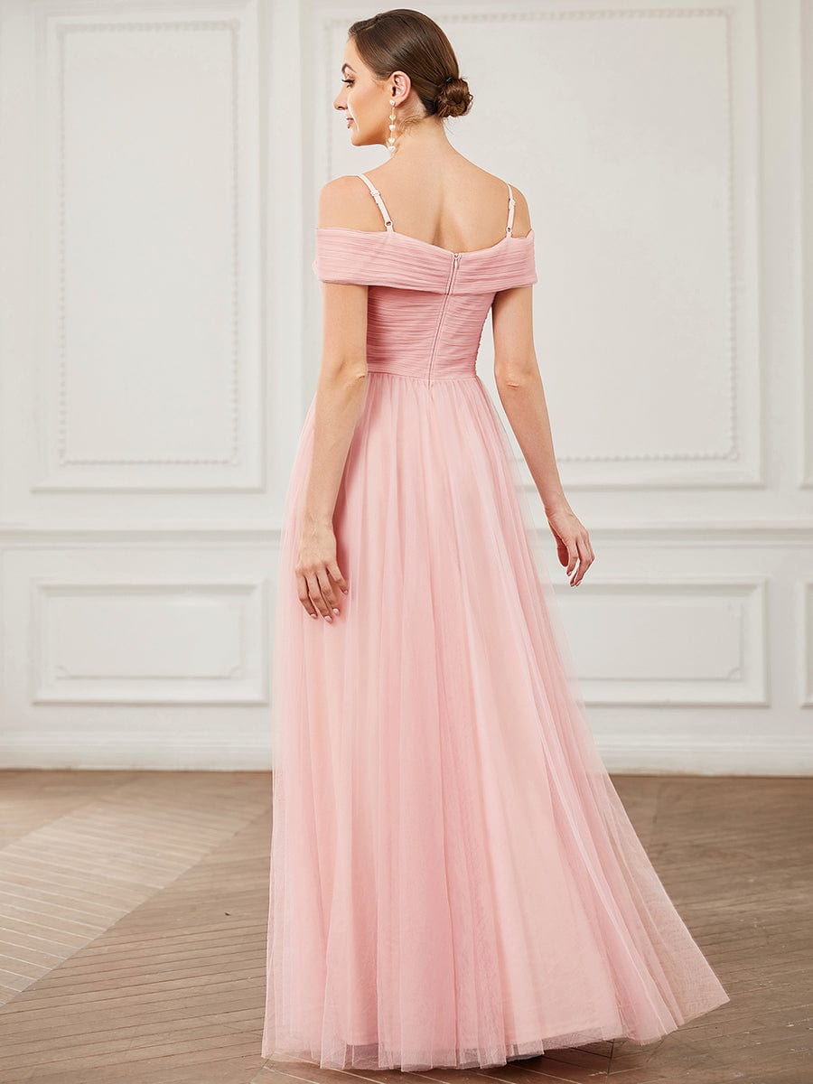 Back view of the pink A-line tulle bridesmaid dress, showing cold shoulder and cross-over detail.