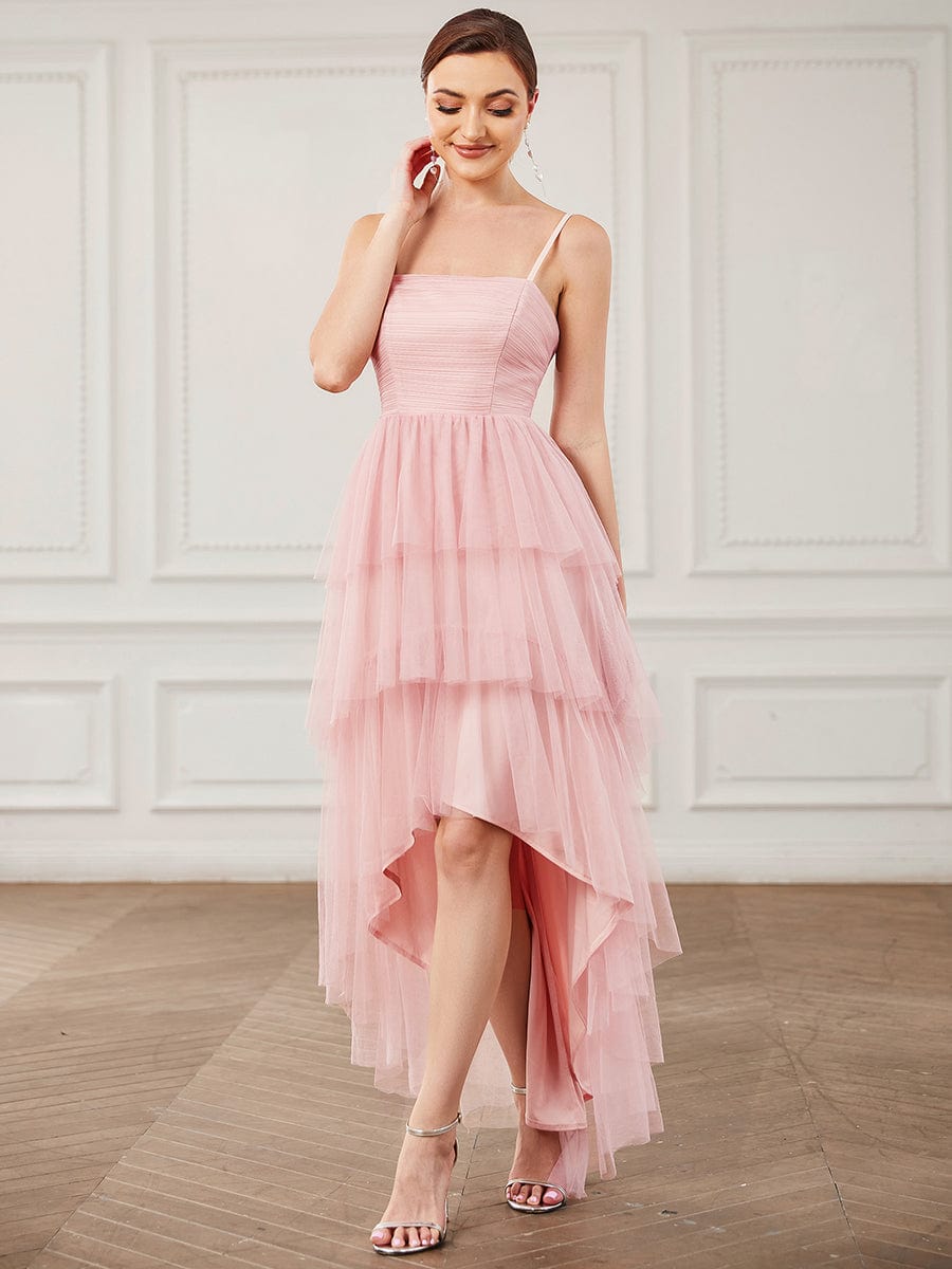 Model wearing an elegant blush pink tulle high-low bridesmaid dress.