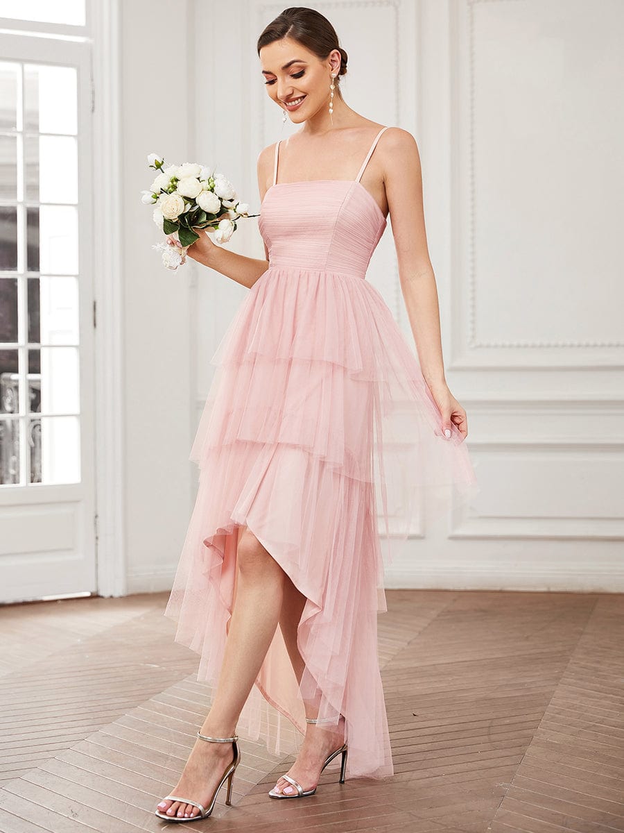 Back view of a blush pink spaghetti strap tulle bridesmaid dress.
