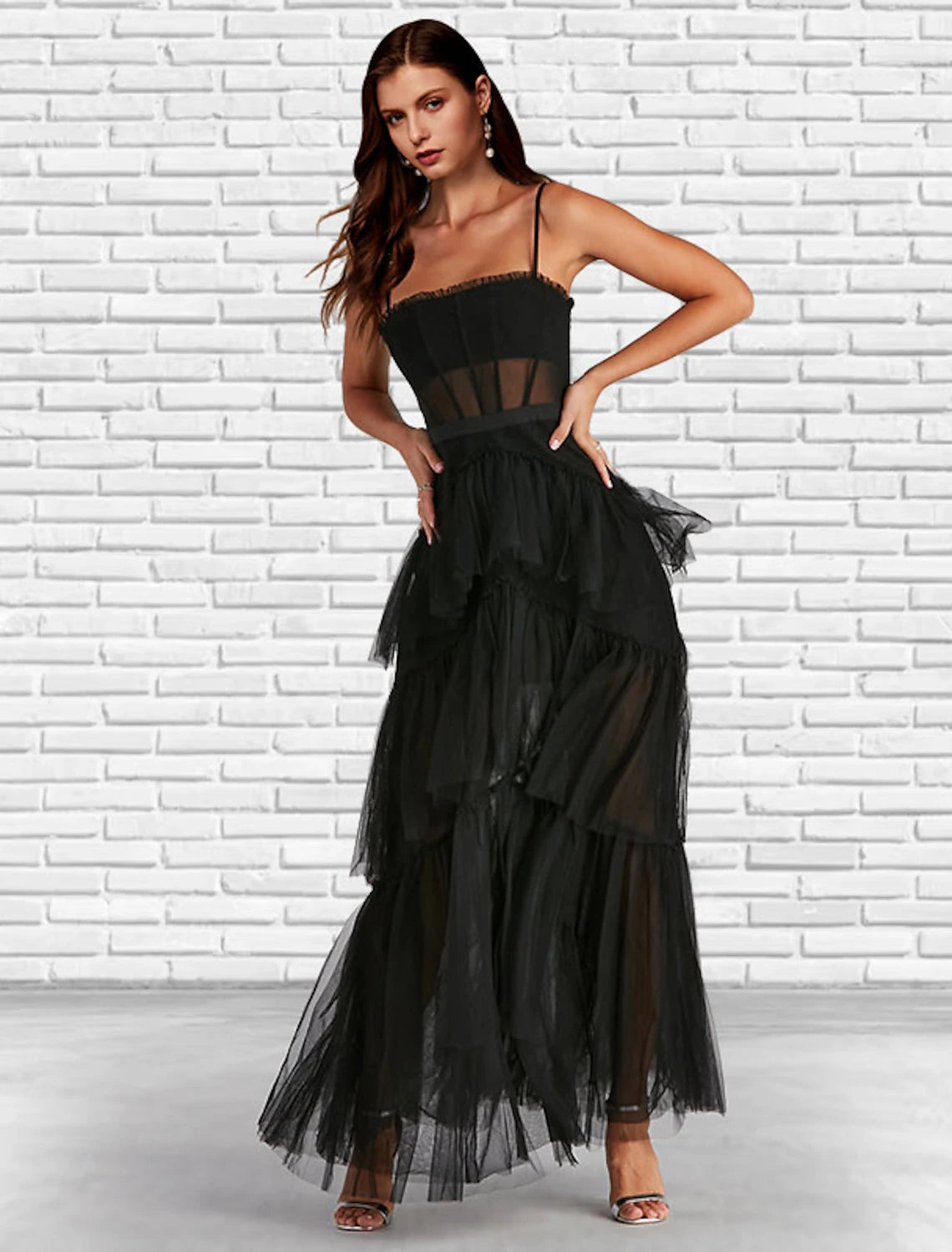 Side profile of a model in an elegant strapless tulle gown, highlighting the ankle length.