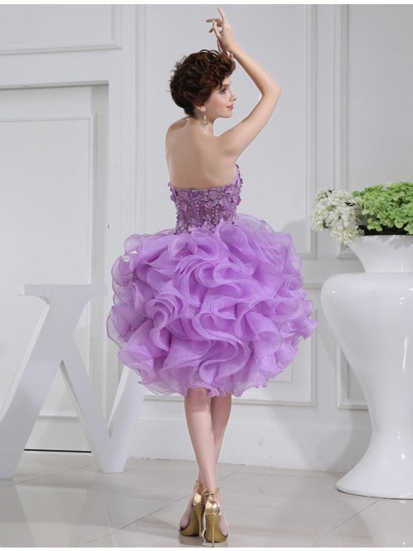 Elegant organza cocktail dress featuring a sleeveless A-line silhouette.
