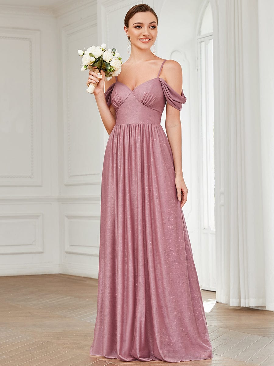 Model wearing a rust-colored draped sleeve cold shoulder sweetheart A-line bridesmaid dress.