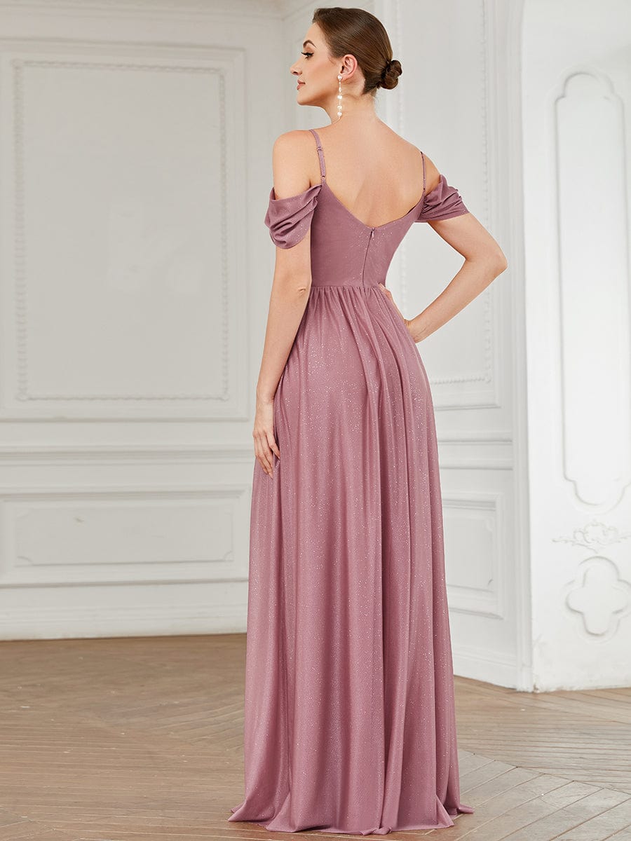 Back view of a model in a rust-colored draped sleeve cold shoulder bridesmaid dress.