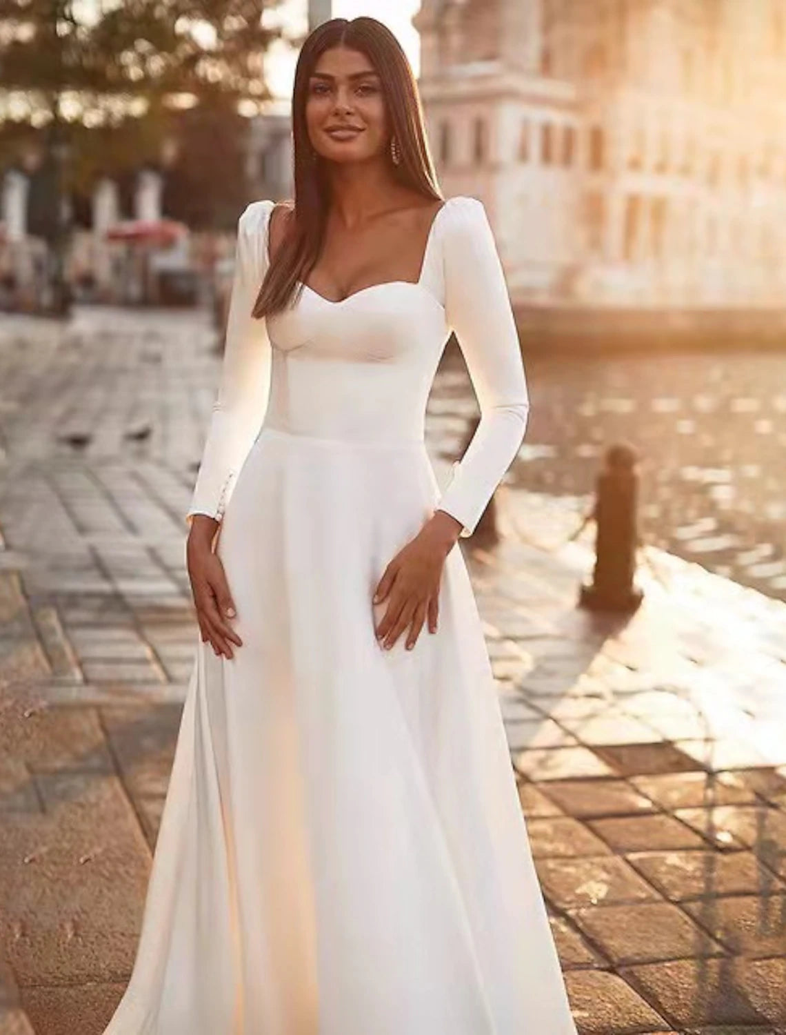 Back view of the satin wedding guest dress, highlighting the sweep train and long sleeves.